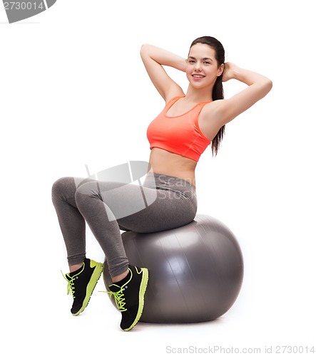 Image of teenage girl doing exercise on fitness ball