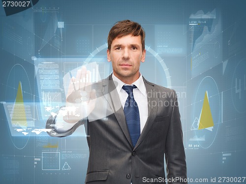 Image of attractive buisnessman wotking with virtual screen