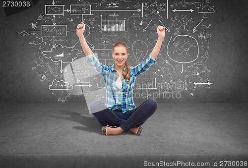 Image of young woman in casual clothes sitting on floor