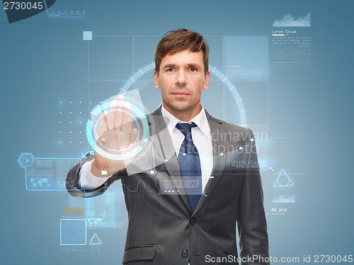 Image of attractive buisnessman wotking with virtual screen