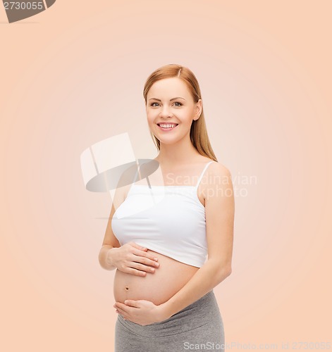Image of happy future mother touching her belly