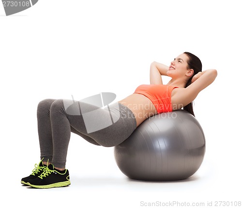 Image of teenage girl doing exercise on fitness ball