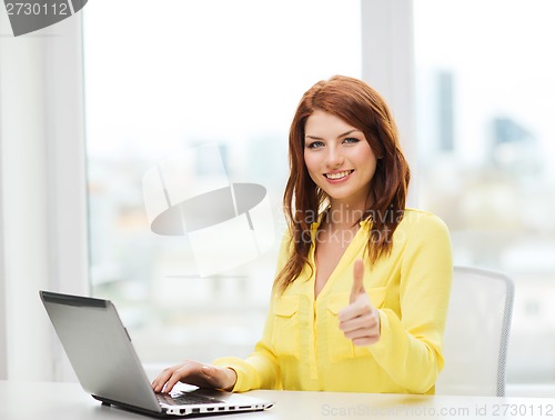 Image of smiling student with laptop computer at school