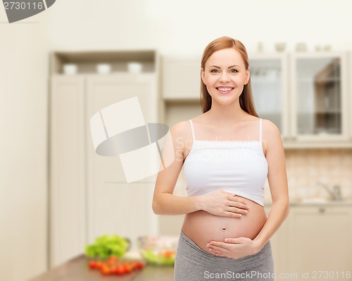 Image of happy future mother touching her belly