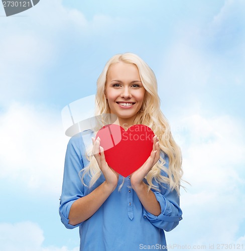 Image of smiling woman with red heart