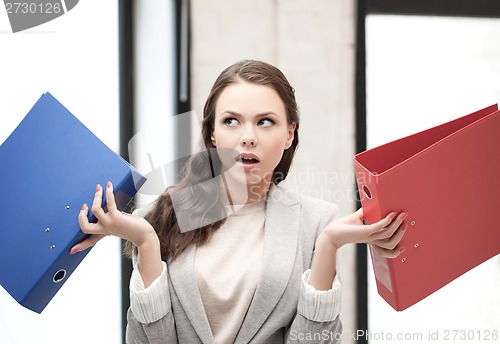 Image of unsure thinking or wondering woman with folder