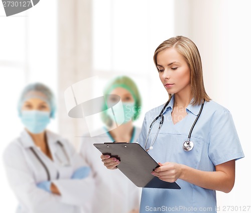 Image of smiling female doctor or nurse with clipboard