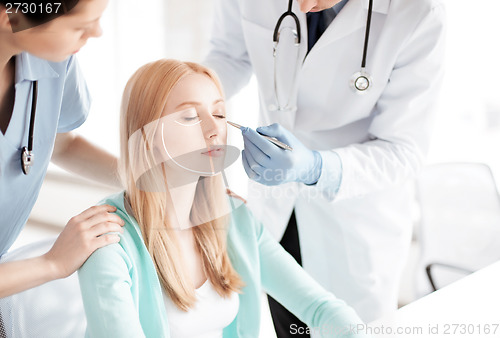 Image of male plastic surgeon with patient