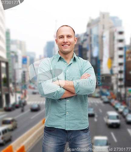 Image of smiling man with crossed arms