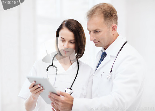 Image of two doctors looking at tablet pc