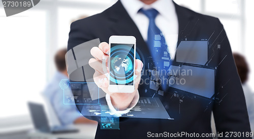 Image of businessman showing smartphone with blank screen