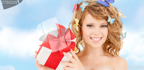 Image of teenager with butterflies in hair showing present