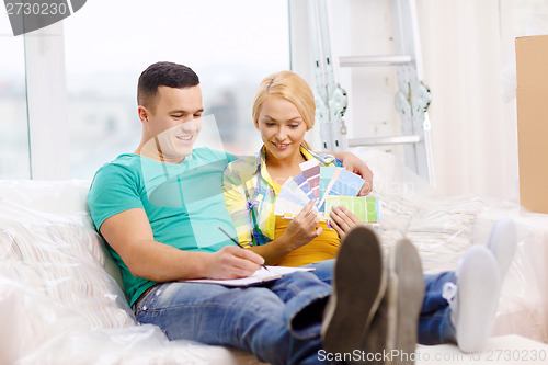 Image of couple looking at color samples in new home