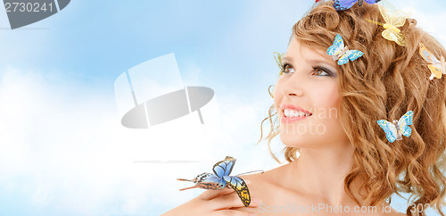 Image of happy teenage girl with butterflies in hair