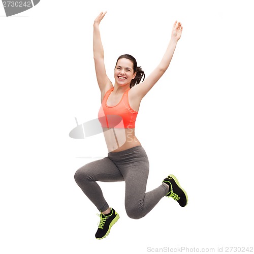 Image of sporty teenage girl jumping in sportswear