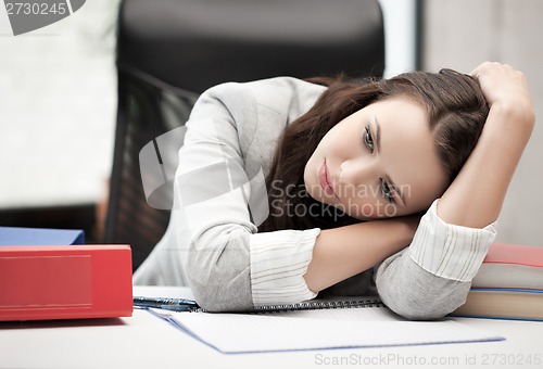 Image of bored and tired woman behid the table