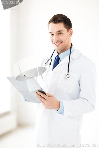 Image of male doctor writing prescription