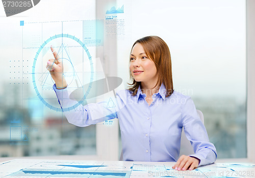 Image of smiling businesswoman working with virtual screen