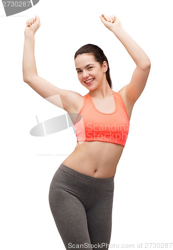 Image of smiling teenage girl in sportswear dancing