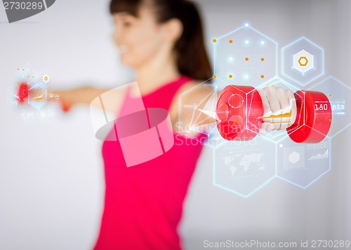 Image of sporty woman hands with light red dumbbells