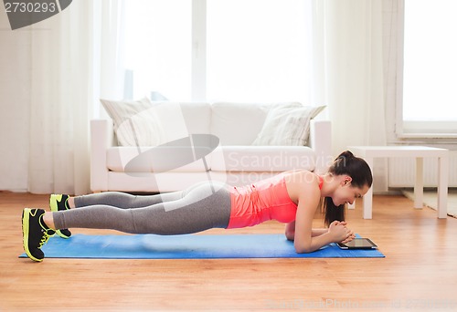 Image of smiling redhead teenage girl doing plank at home