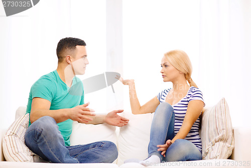 Image of unhappy couple having argument at home