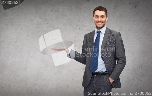 Image of man showing something on the palm of his hand