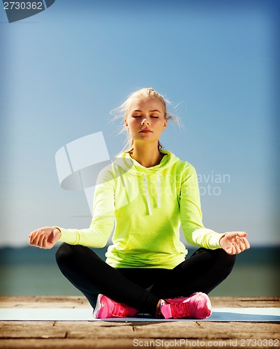 Image of woman doing yoga outdoors