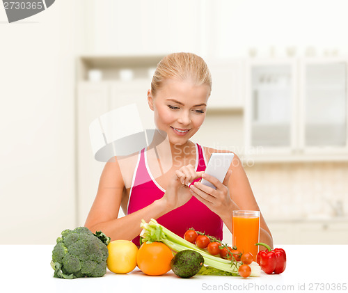 Image of woman with vegetables pointing at smartphone