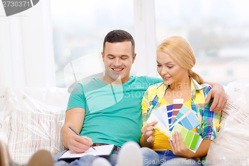 Image of couple looking at color samples in new home