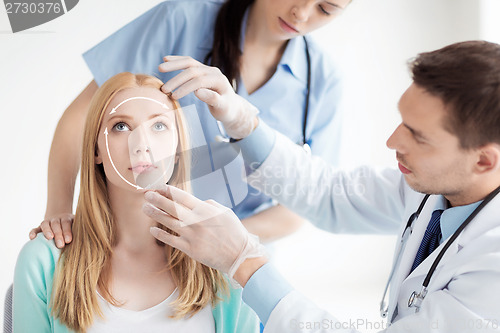 Image of male plastic surgeon with patient