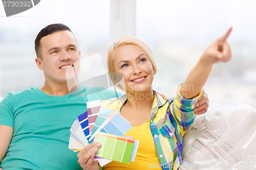 Image of couple looking at color samples in new home