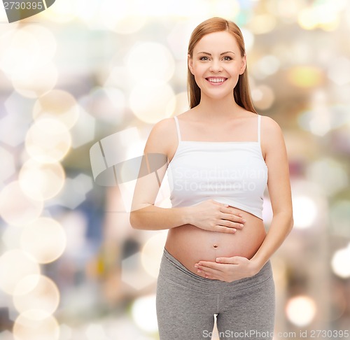 Image of happy future mother touching her belly