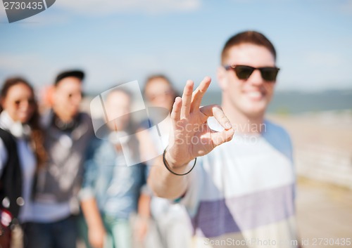 Image of close up of male hand showing ok sing with fingers