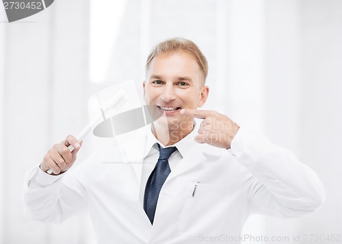 Image of dentist with toothbrush in hospital