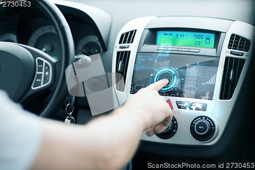 Image of man using car control panel