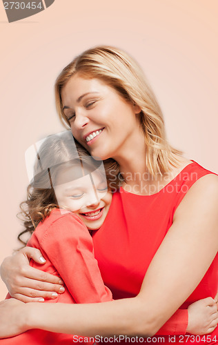 Image of smiling mother and daughter hugging