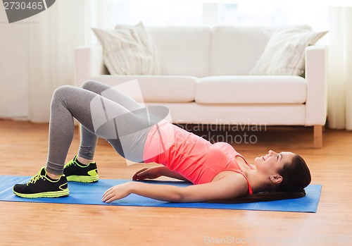 Image of smiling girl doing exercise for legs and buttocks
