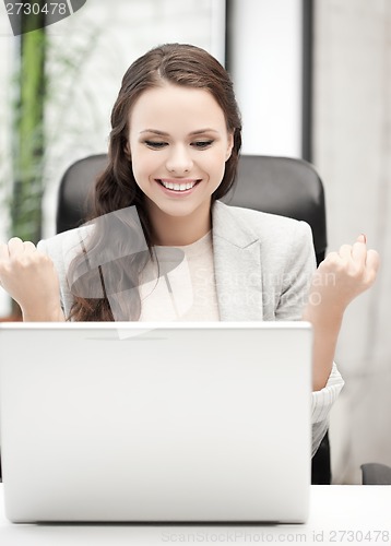 Image of smiling businesswoman celebrating victory or win