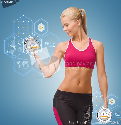 Image of smiling woman lifting steel dumbbell