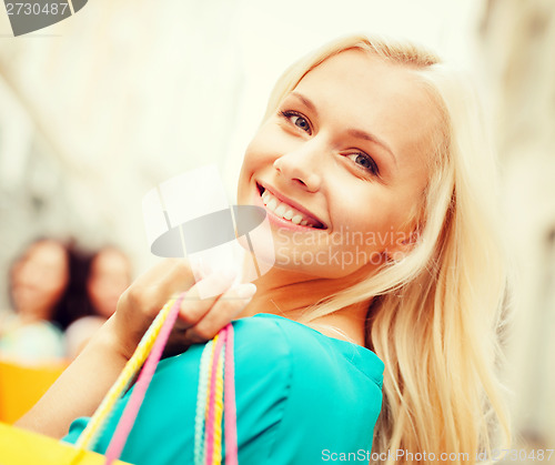 Image of woman with shopping bags in ctiy