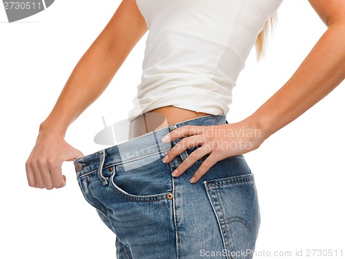 Image of close up of female showing big jeans