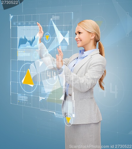 Image of smiling businesswoman working with virtual screen