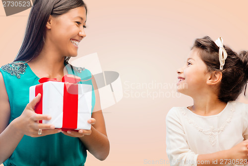 Image of happy mother and child girl with gift box