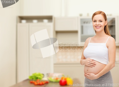 Image of happy future mother touching her belly