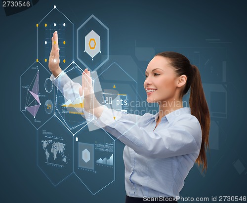 Image of smiling businesswoman working with virtual screen