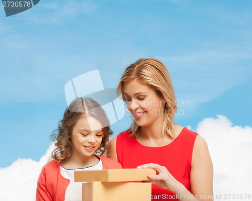 Image of smiling mother and daughter with gift box
