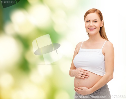 Image of happy future mother touching her belly