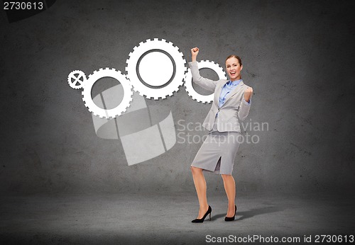 Image of happy businesswoman with hands up