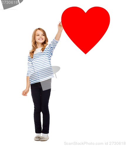 Image of girl drawing big red heart in the air